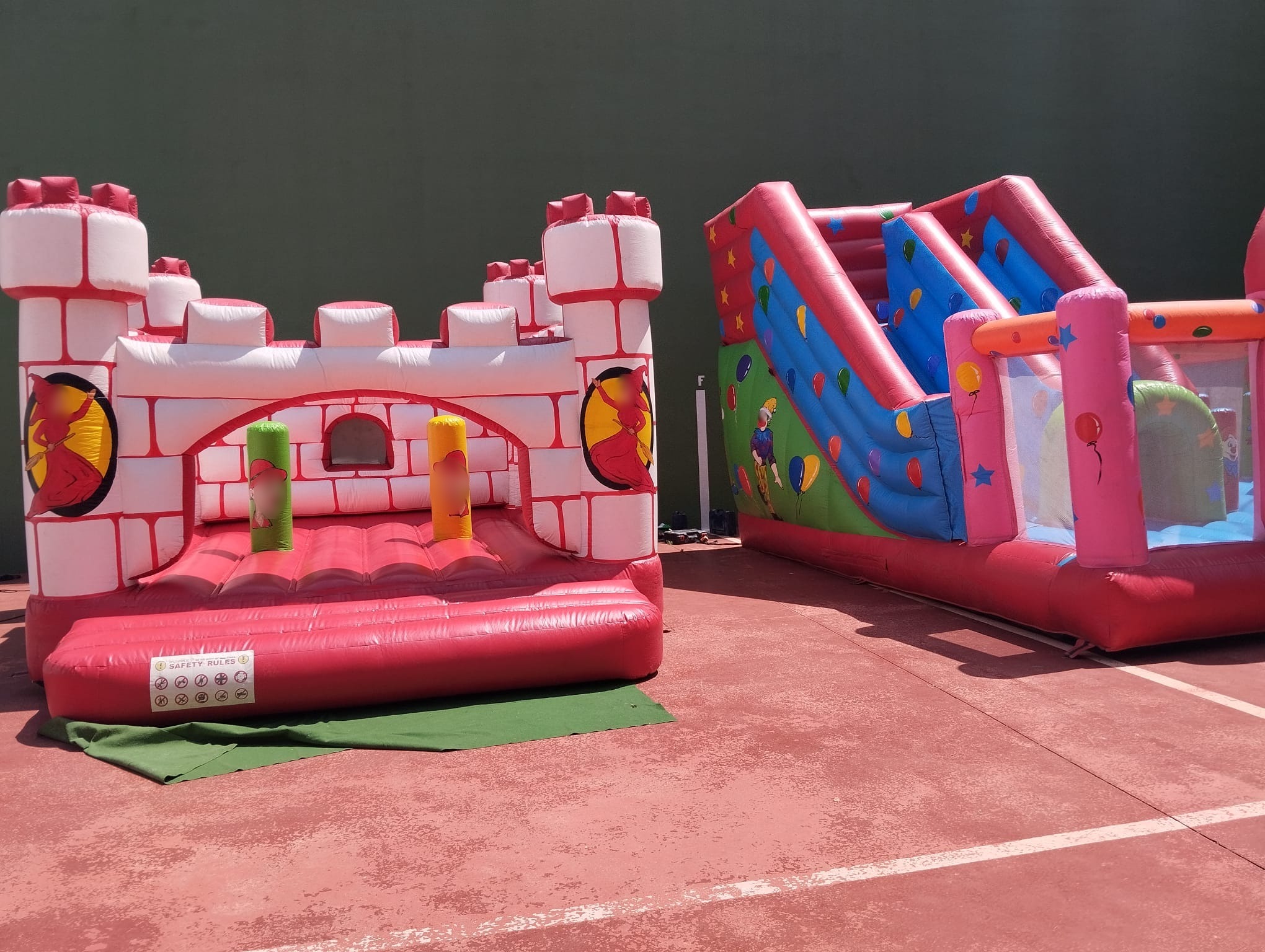 Castillo hinchable medieval con tobogán en pista deportiva